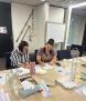 Two people sitting at a table completing the workshop guide