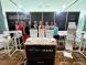 A group of IHACPA staff standing at the IHACPA exhibition booth